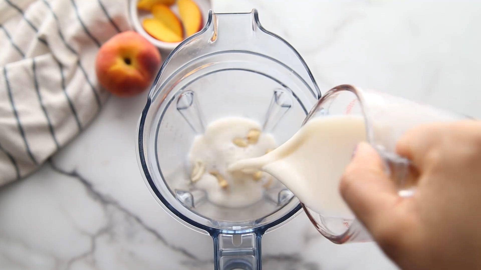 pouring almond milk into blender