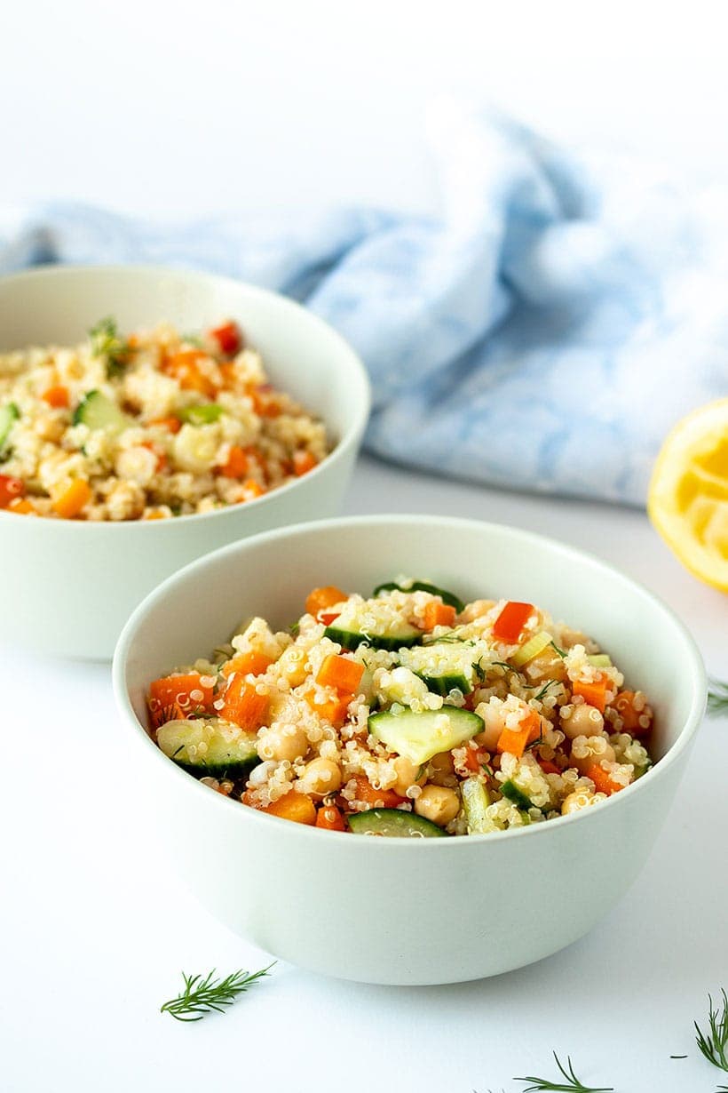 quinoa chickpea salad in off-white bowls