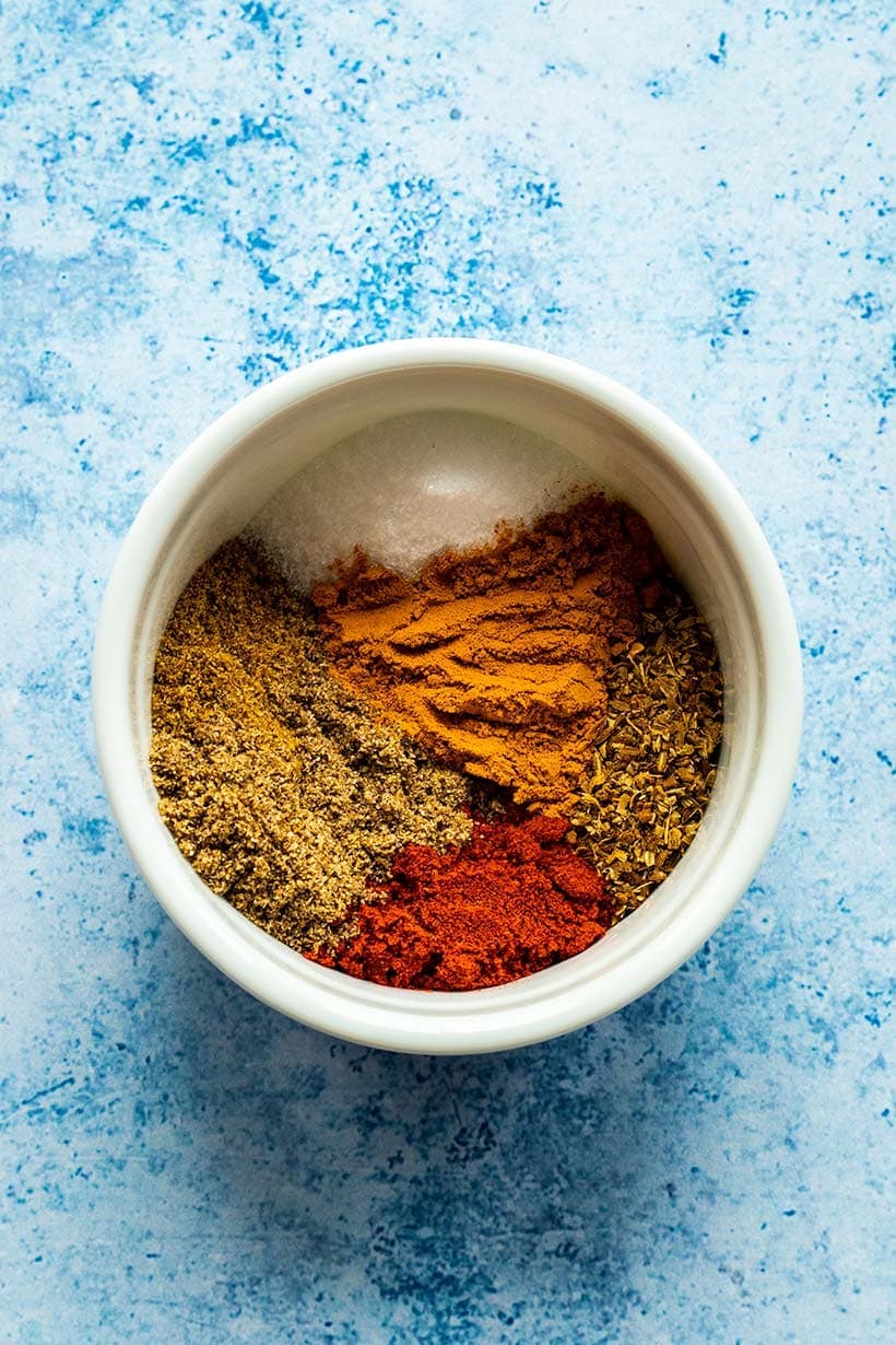 Tikka masala spice blend in a white bowl viewed from overhead