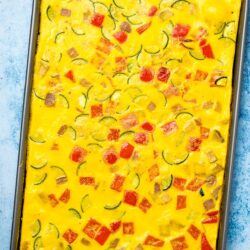 Cooked mixed vegetable sheet pan omelette in a grey sheet pan