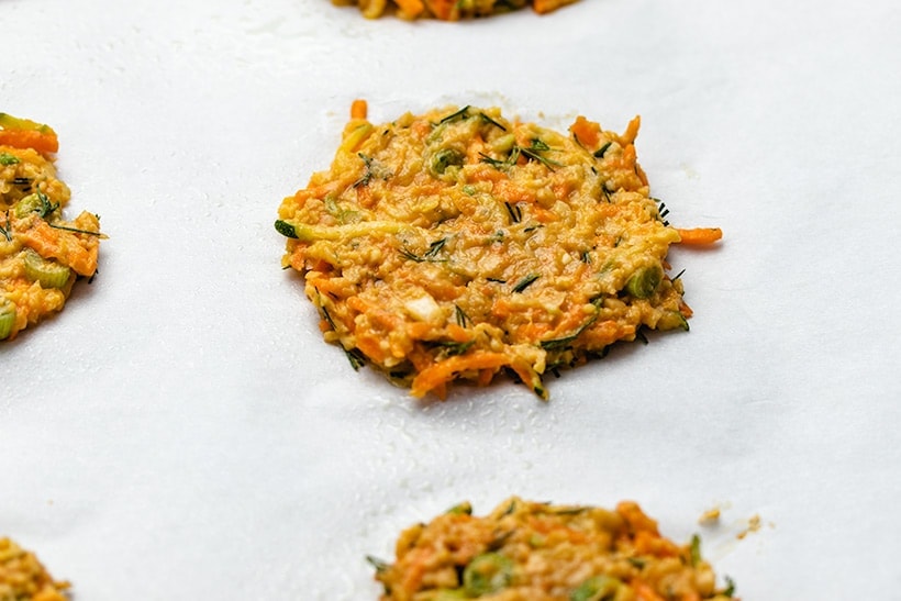uncooked zucchini carrot fritters on a sheet pan
