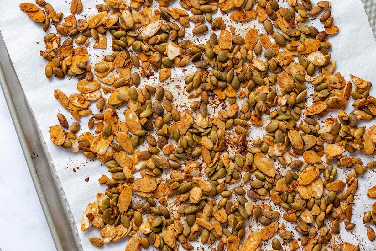 tamari roasted almond slices and pumpkin seeds on a baking sheet lined with parchment paper