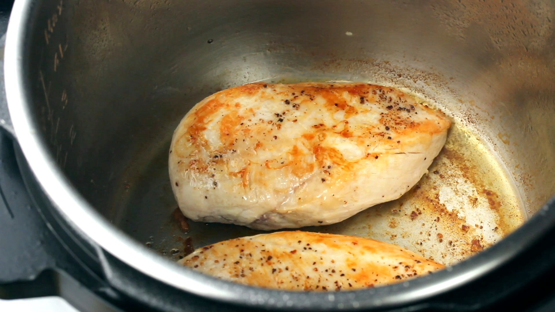 Two seared chicken breasts in the Instant Pot