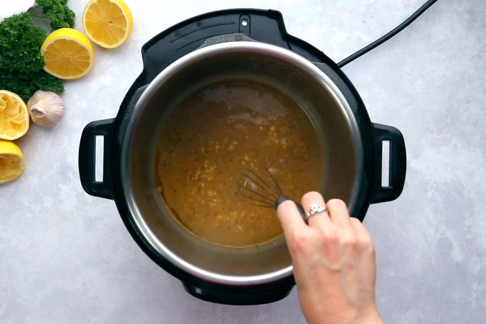 whisking cornstarch slurry into lemon garlic sauce in an Instant Pot