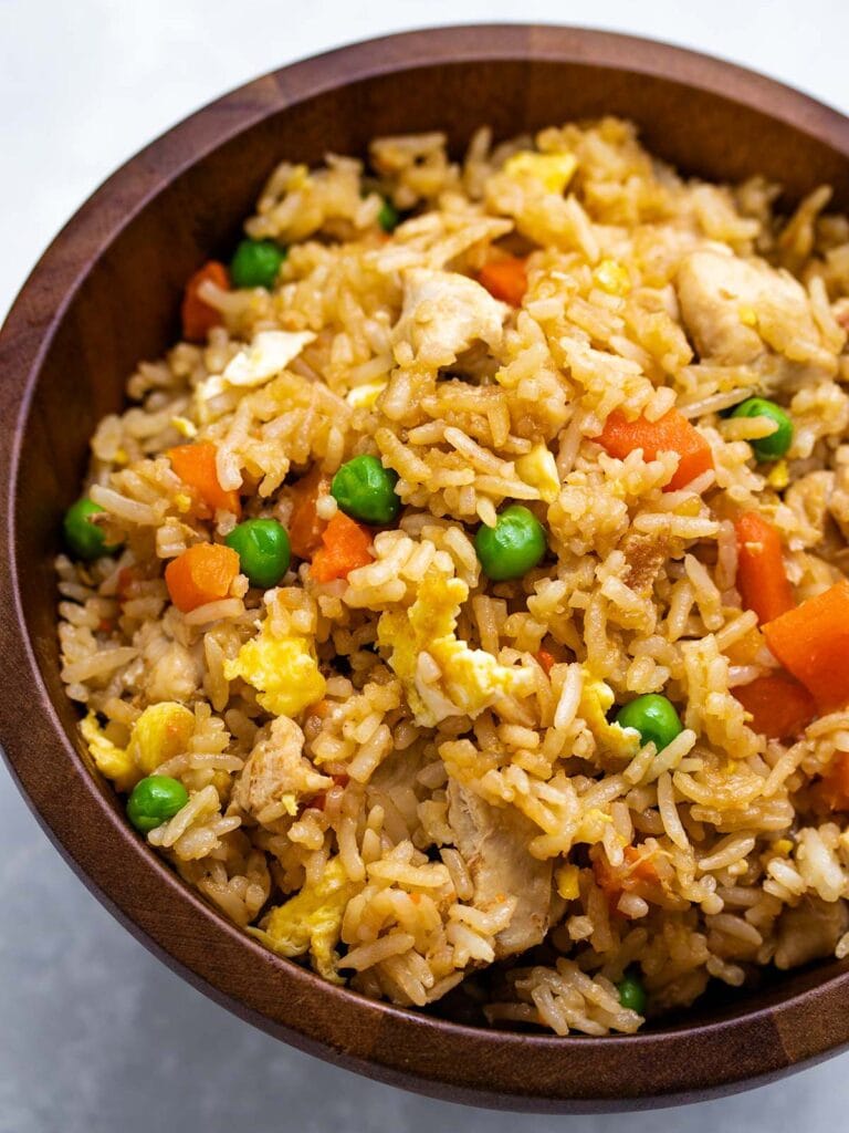 Instant Pot chicken fried rice in a wooden bowl.