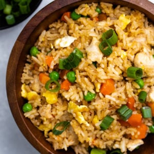 Instant Pot Chicken Fried Rice in a wooden bowl garnished with green onion.