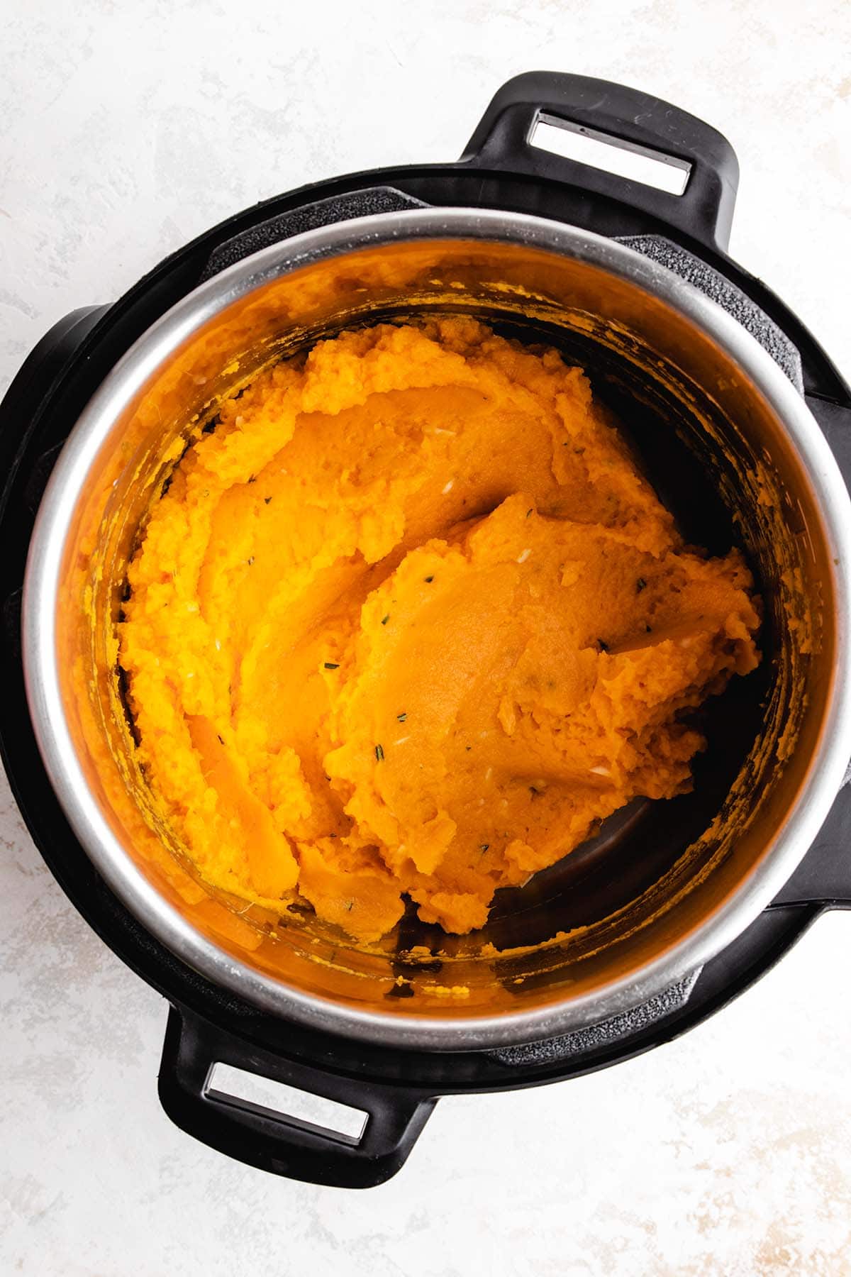 Garlic rosemary mashed sweet potatoes in an Instant Pot, viewed from overhead.