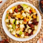 Fall Fruit Salad in a white bowl viewed from overhead.