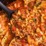 Slow Cooker Lasagna Soup being scooped by a black ladle.